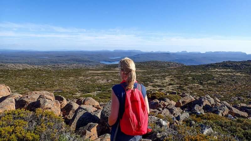 Woman looks across to The Overland Track from Walls of Jerusalem NP