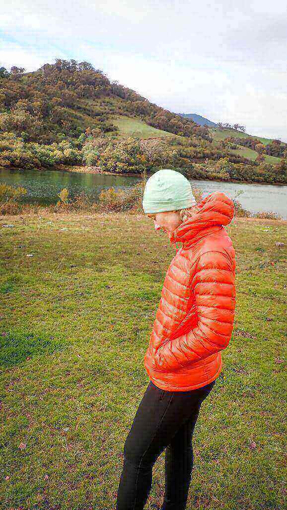 Woman in orange down jacket and beanie