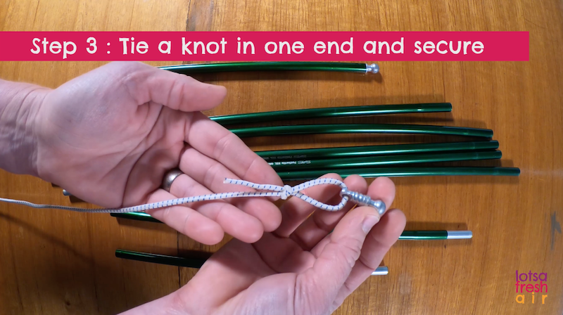 Tie a knot in one end of the shock cord before feeding through