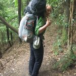 Person carrying 2 backpacks